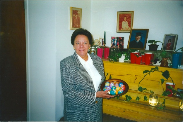 My mom, our living room, Easter 1998. I have no idea what she's trying to grow in the red solo cups...